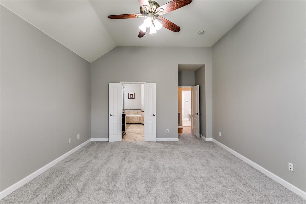 4532 Crown Ridge Drive Plano, TX 75024 - Photo 18 of 25 Spacious room featuring vaulted ceilings and a ceiling fan with light fixture