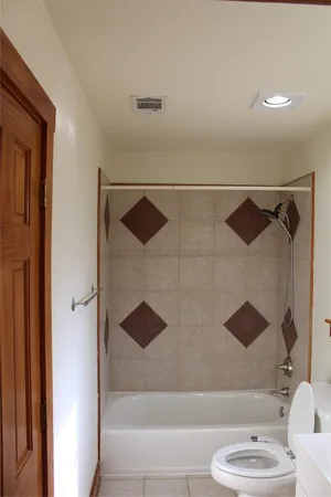 a bathroom with a bathtub and a shower