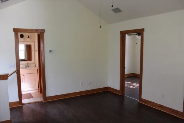 an empty room with wooden floor and closet