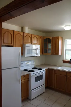 a kitchen with a stove sink and refrigerator
