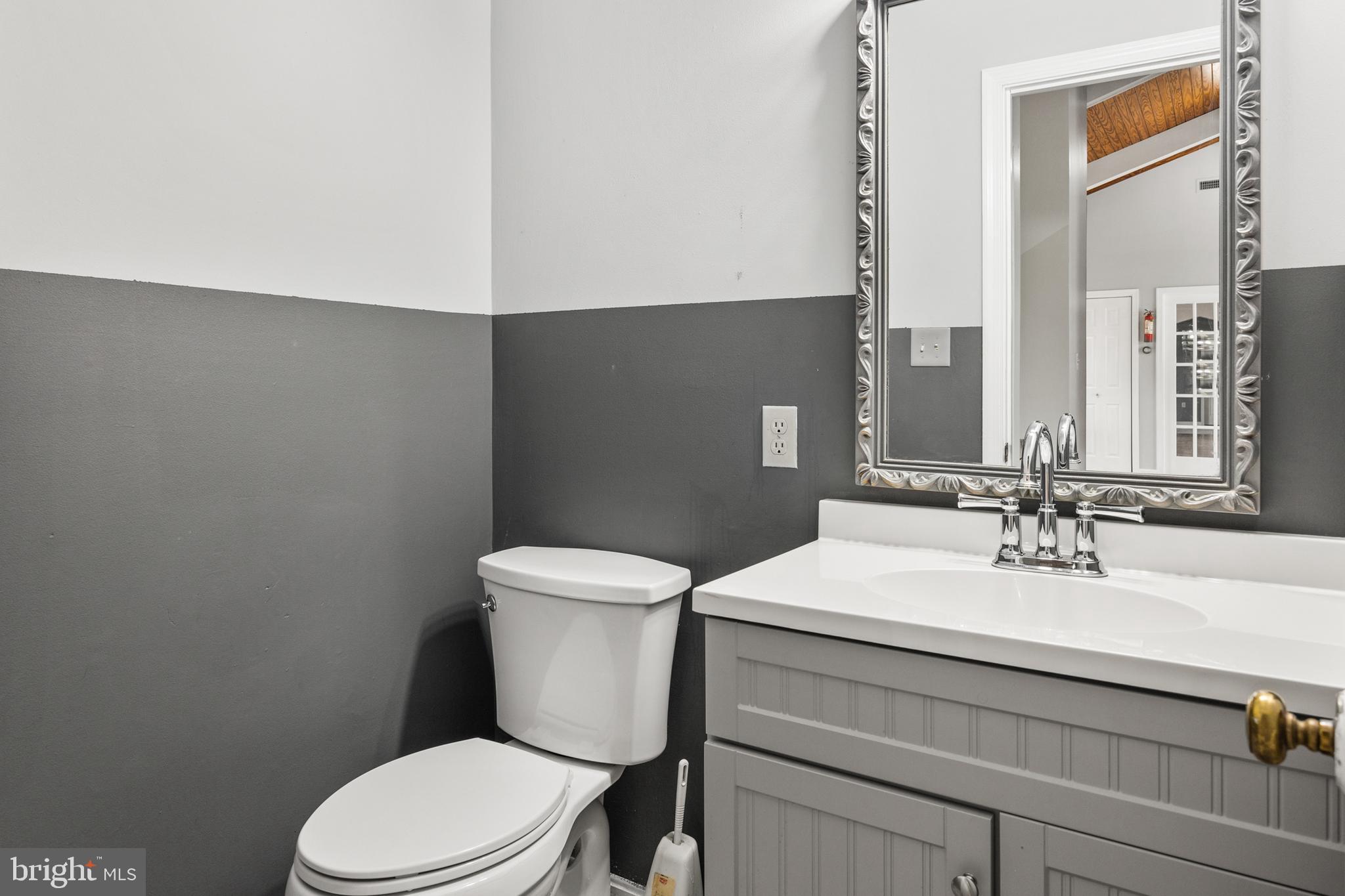 2370 Highway 211 Luray, VA 22835 - Photo 23 of 68 a bathroom with a sink mirror vanity and toilet