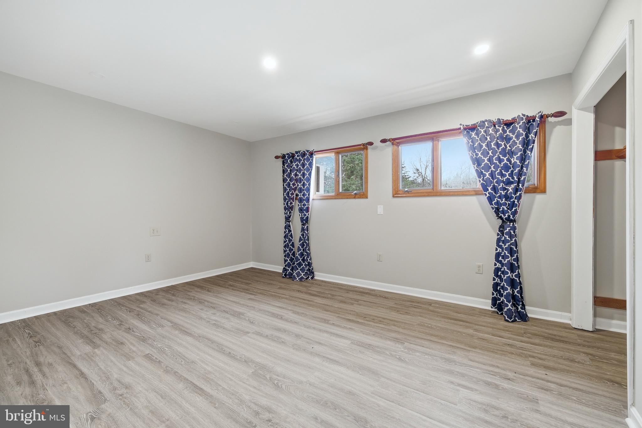 2370 Highway 211 Luray, VA 22835 - Photo 41 of 68 an empty room with wooden floor and windows
