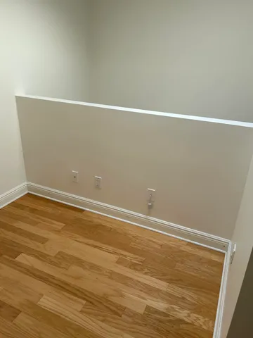 a view of a room with wooden floor