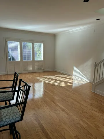 a view of a livingroom with wooden floor and a window