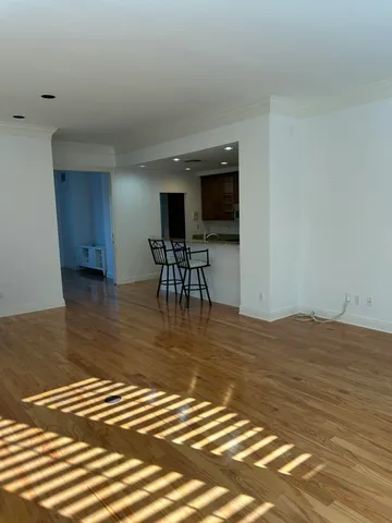a view of a room with wooden floor and furniture