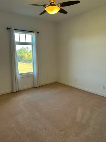 an empty room with a window and fireplace