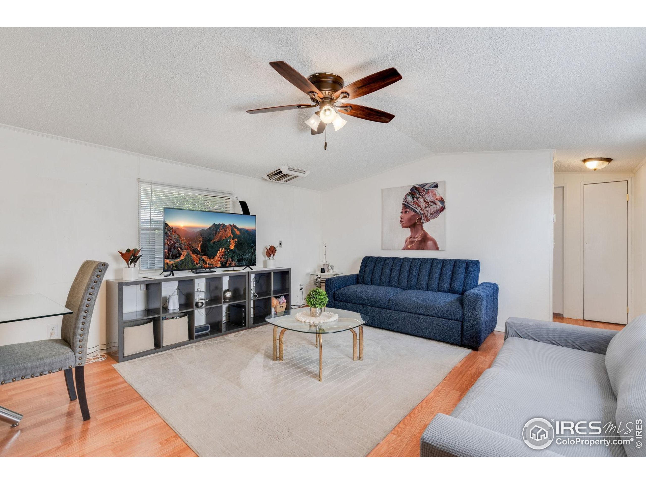 a living room with furniture and a dining table