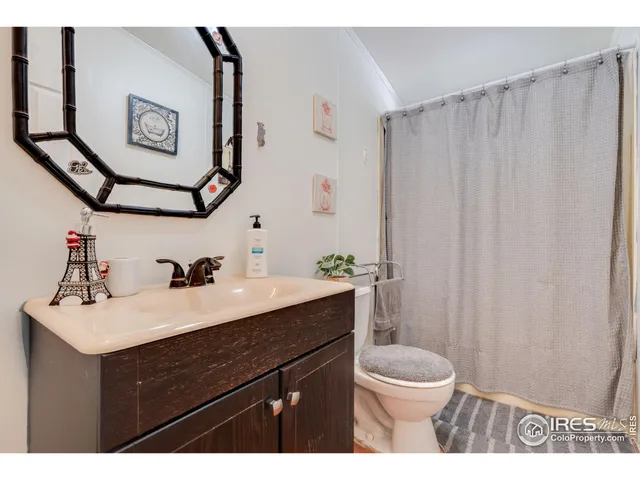 a bathroom with a sink vanity mirror and toilet