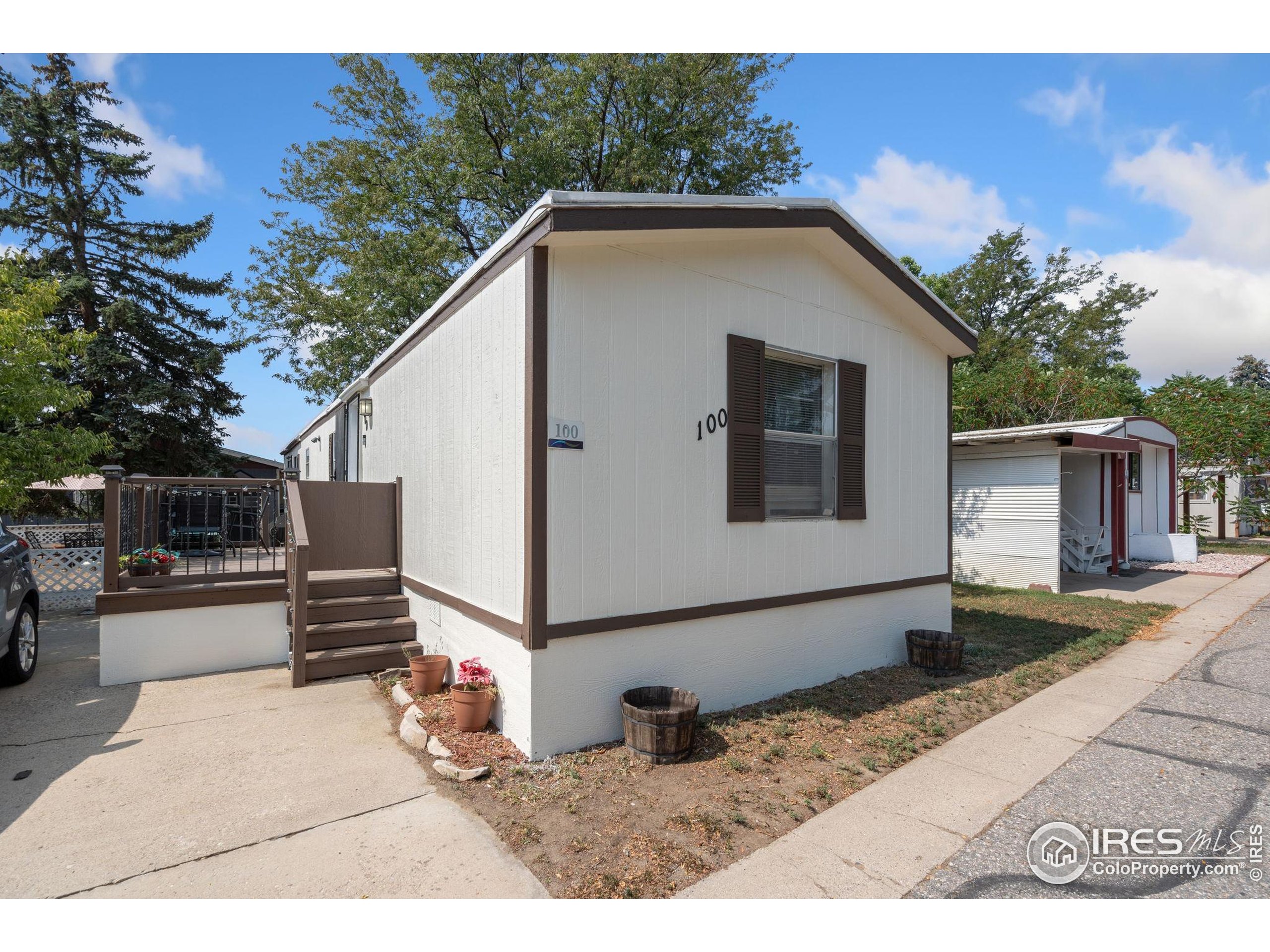4105 North Garfield Avenue, Unit 100 Loveland, CO 80538 - Photo 2 of 17 a view of a backyard with a large tree