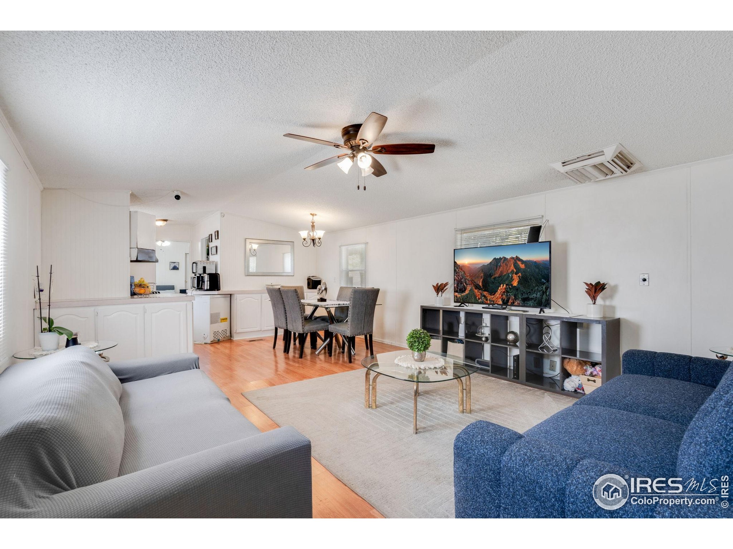 4105 North Garfield Avenue, Unit 100 Loveland, CO 80538 - Photo 5 of 17 a living room with furniture and a view of kitchen