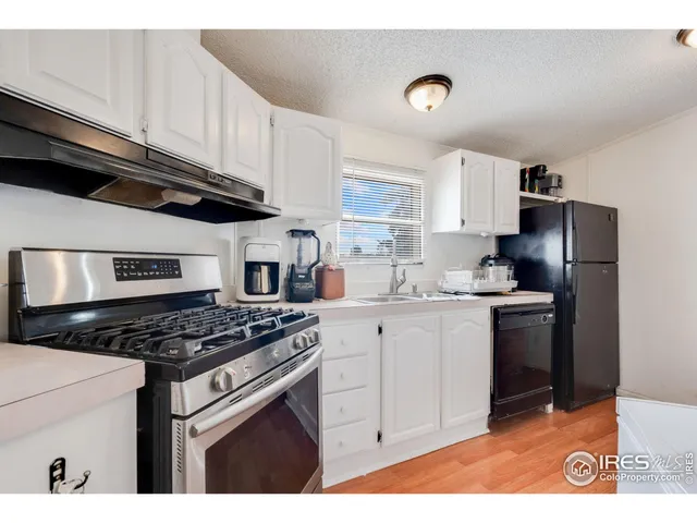 a kitchen with stainless steel appliances granite countertop a stove a sink dishwasher and a refrigerator