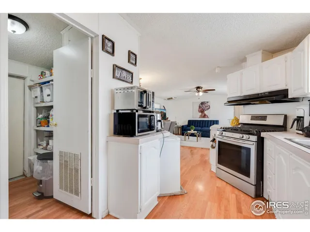 a kitchen with stainless steel appliances granite countertop a refrigerator a stove top oven a sink dishwasher and a refrigerator