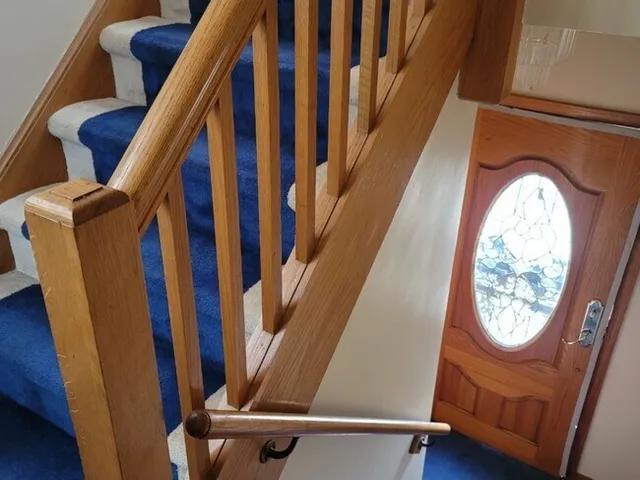a view of staircase with rug and white walls