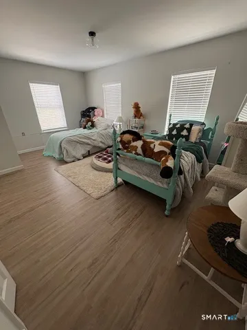 a bedroom with furniture and a window