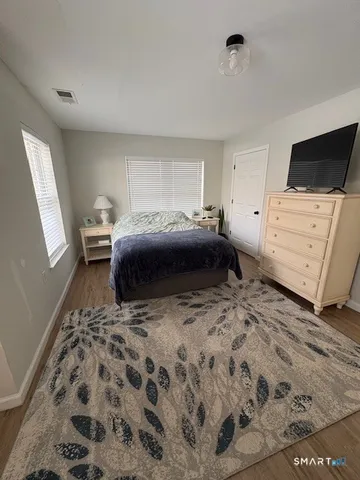 a bedroom with a bed and flat screen tv