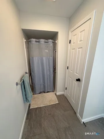 an entryway with wooden floor and a window