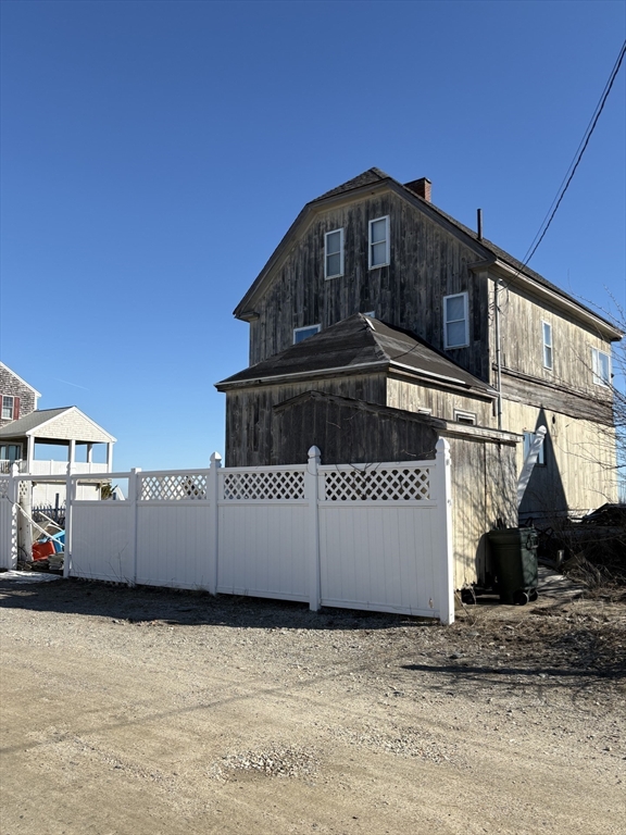 60 N Street Hull, MA 02045 - Photo 20 of 38 a view of a house with a fence in front of it