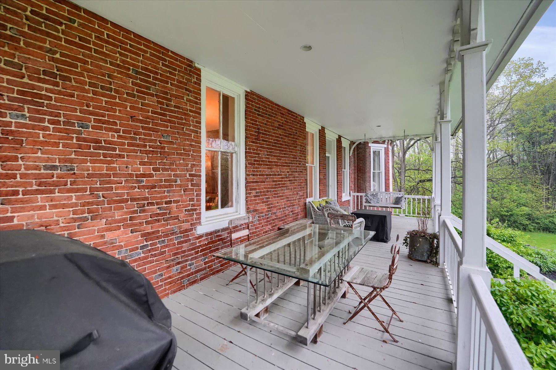 612 Old Rte 322 Spring Mills, PA 16875 - Photo 47 of 79 a balcony view with a couple of chairs and wooden floor