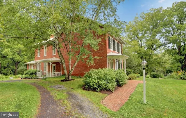 a dining room with furniture a chandelier and wooden floor