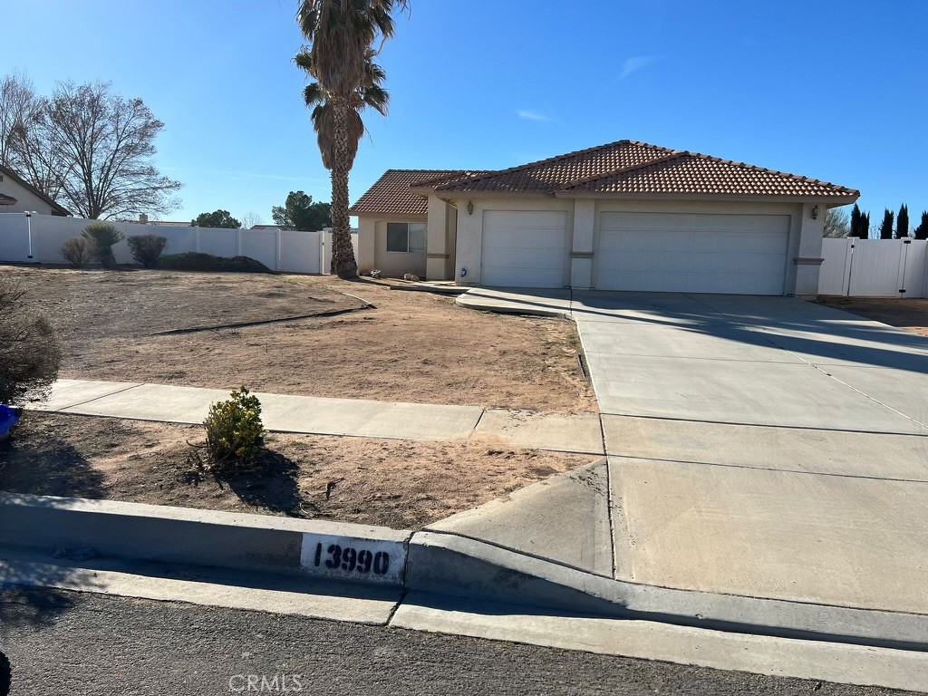 13990 Falling Leaf Road Apple Valley, CA 92307 - Photo 1 of 1 a view of a house with wooden fence