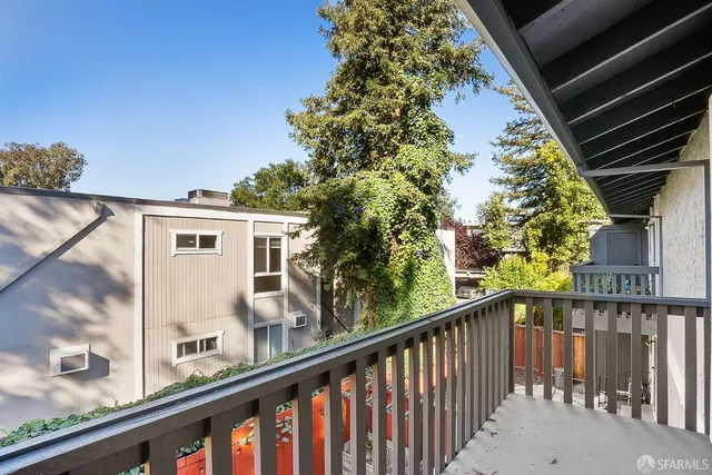 a view of a balcony with a tree