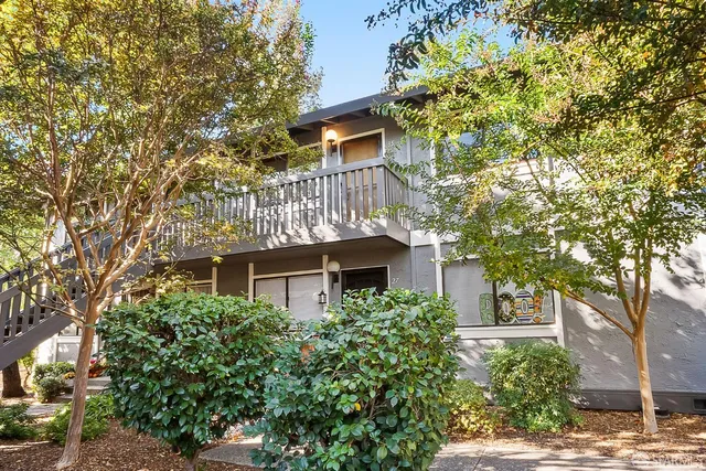 front view of a house with a tree