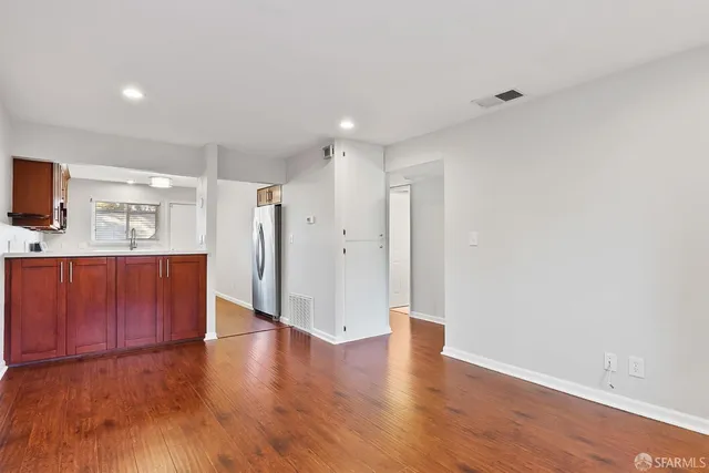 a view of a kitchen with wooden floor