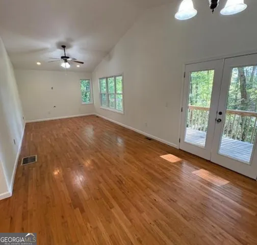 wooden floor in an empty room with a window