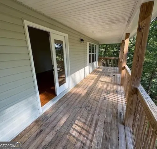 a view of a room with wooden floor and window