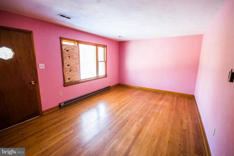 7782 Fort Valley Road Fort Valley, VA 22652 - Photo 18 of 30 an empty room with wooden floor and windows