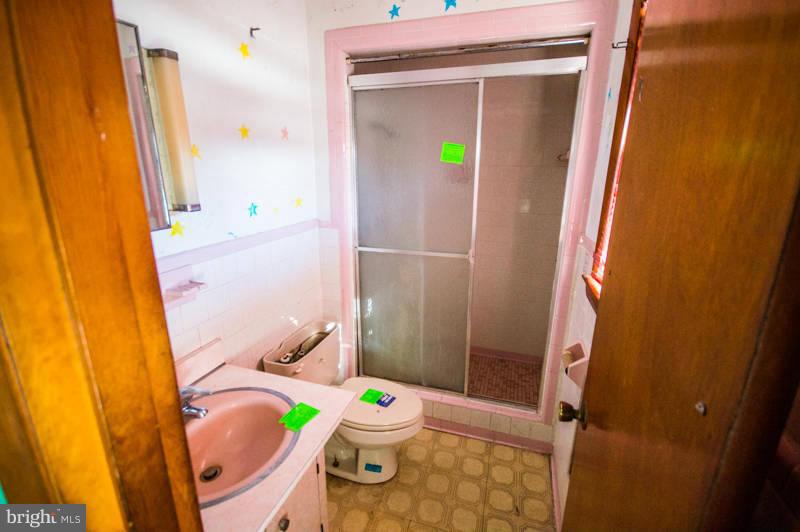 7782 Fort Valley Road Fort Valley, VA 22652 - Photo 19 of 30 a bathroom with a sink mirror vanity and toilet