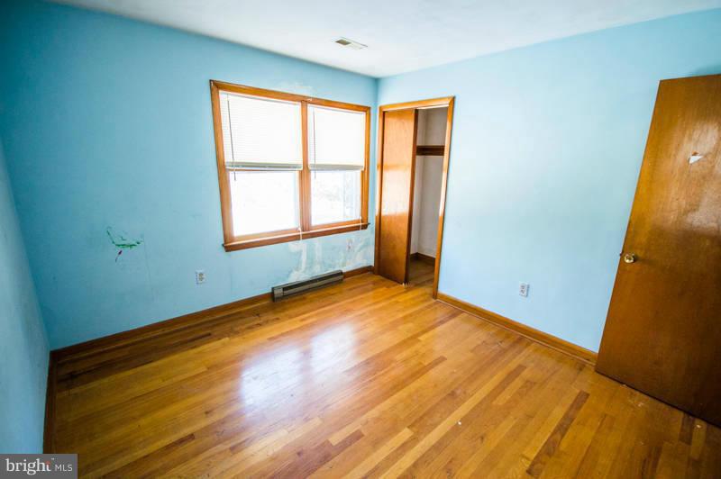 7782 Fort Valley Road Fort Valley, VA 22652 - Photo 25 of 30 a view of an empty room with wooden floor and a window