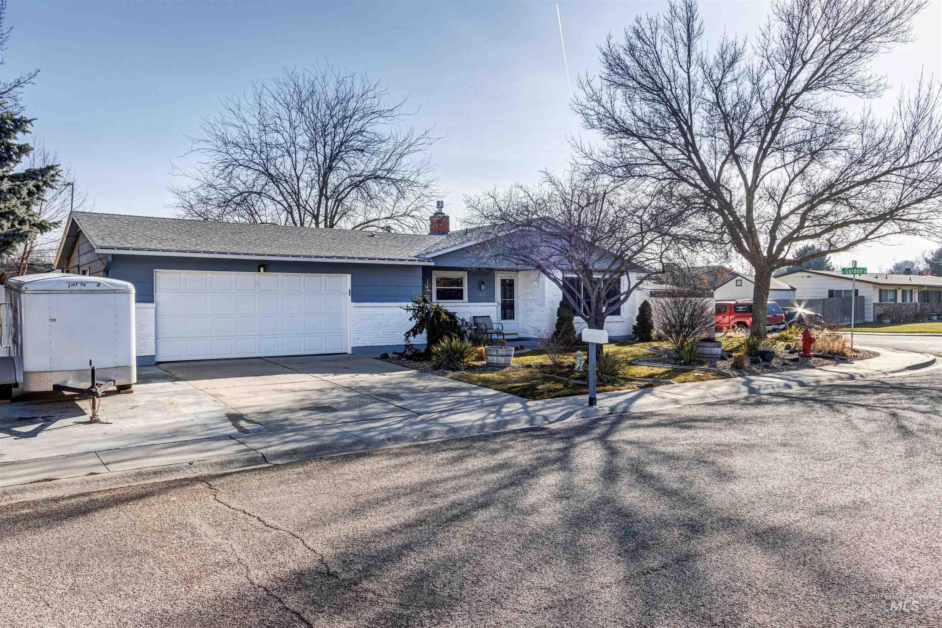 3844 North Patton Street Boise, ID 83704 - Photo 2 of 33 Single story home with concrete driveway, a garage, and a chimney