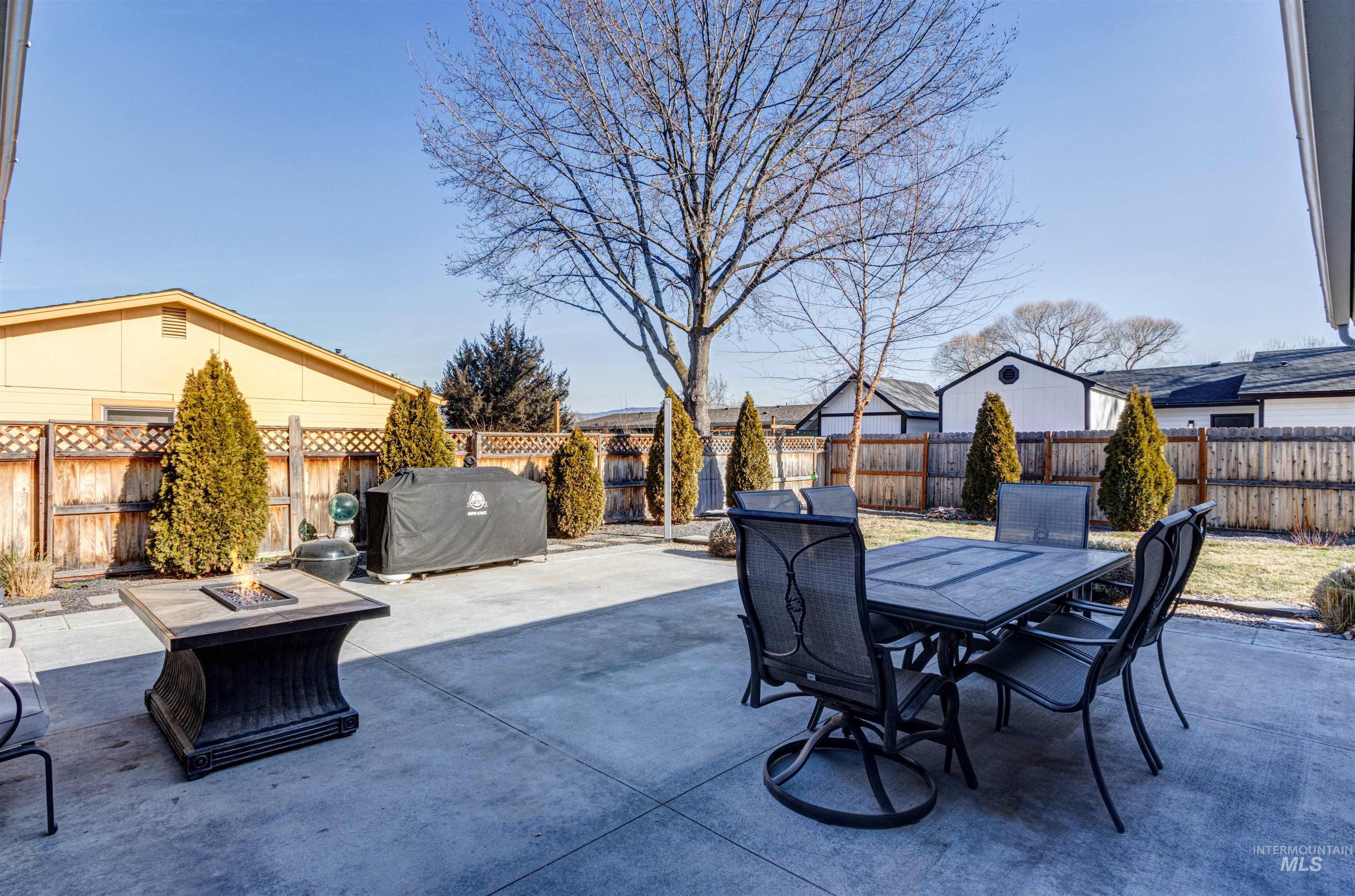 3844 North Patton Street Boise, ID 83704 - Photo 25 of 33 Fenced backyard with an outdoor fire pit, a patio area, and outdoor dining area