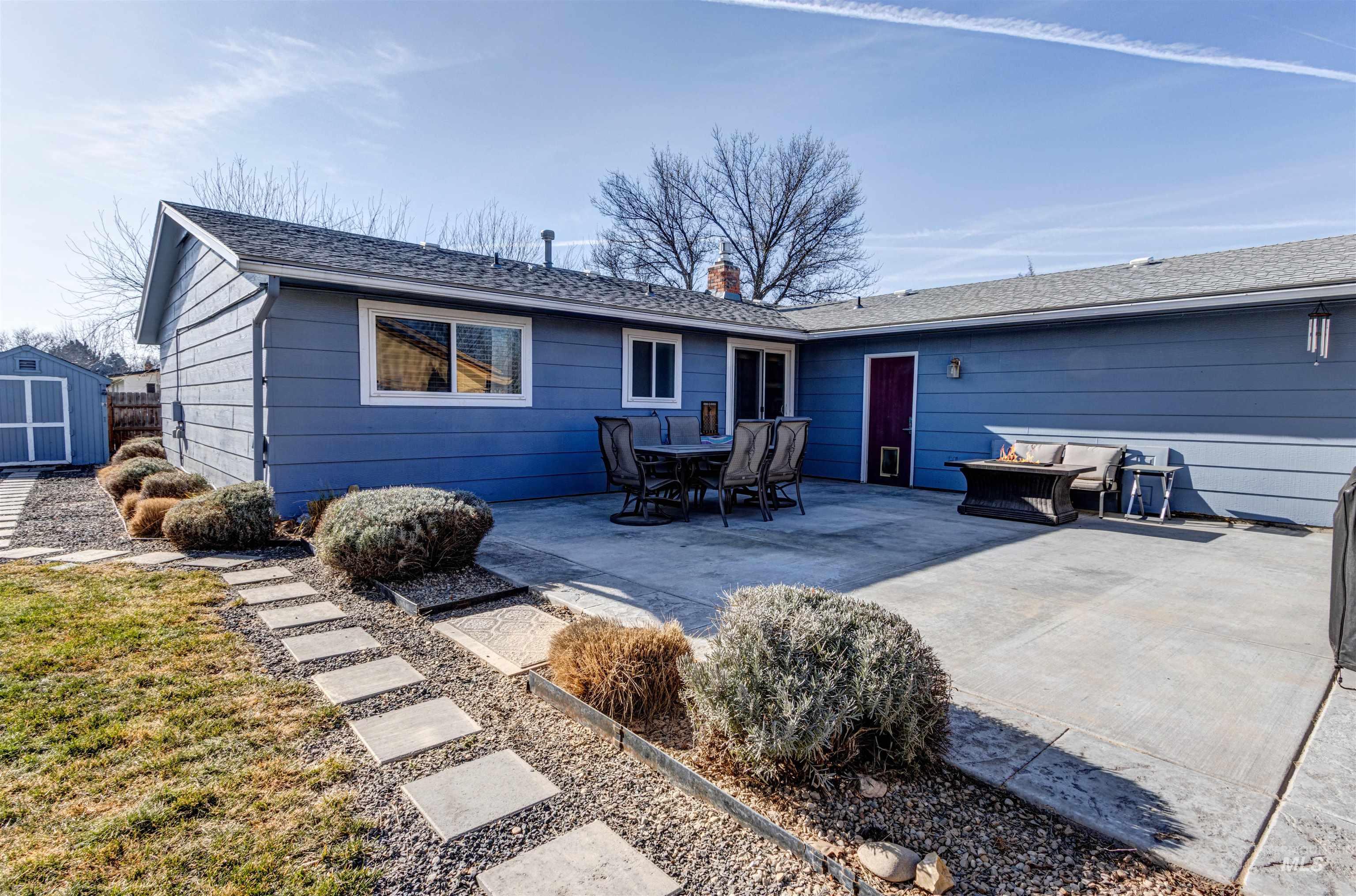 3844 North Patton Street Boise, ID 83704 - Photo 27 of 33 Back of house with a patio area, outdoor dining area, a shed, a shingled roof, and a chimney
