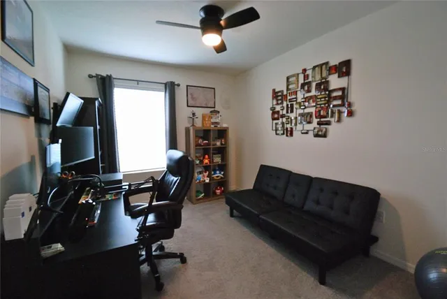 a living room with furniture gym equipment and a window
