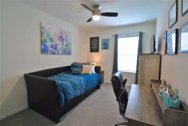 a bedroom with furniture and a window