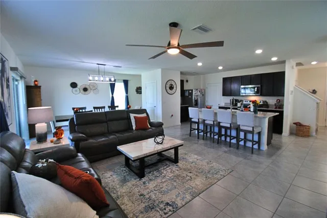 a living room with furniture and kitchen view