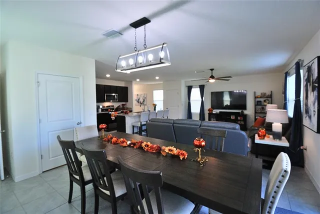 a view of a dining room with furniture and a chandelier