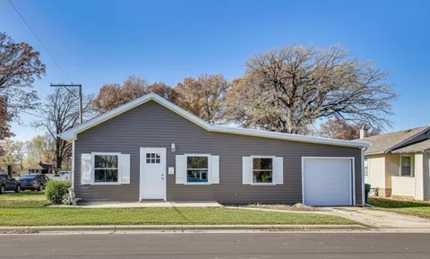 a house that has a tree in front of it