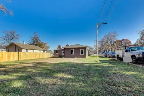 a big house with a big yard and large trees