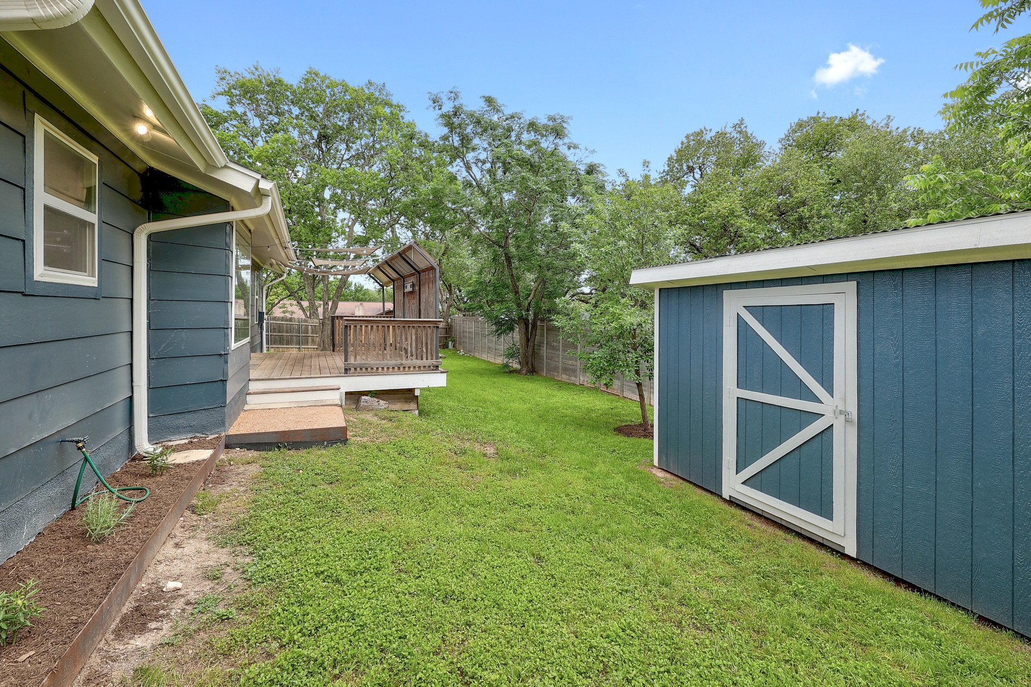 9614 Chukar Circle Austin, TX 78758 - Photo 26 of 26 On the other side of the deck there is a convenient garden shed and additional lawn space for gardening and more.