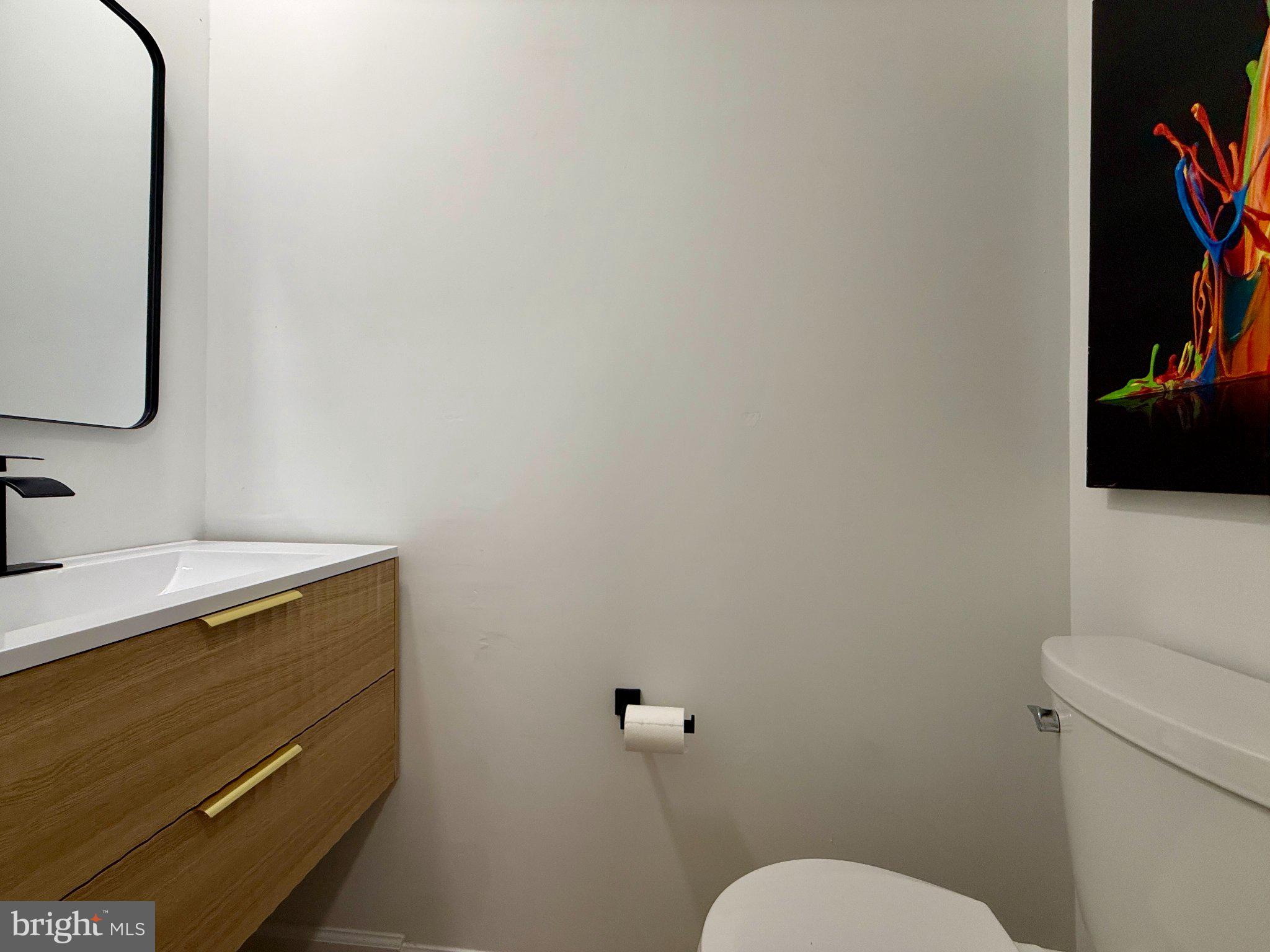 815 Whitehall Street Silver Spring, MD 20901 - Photo 12 of 39 Sleek modern bathroom with vibrant art.