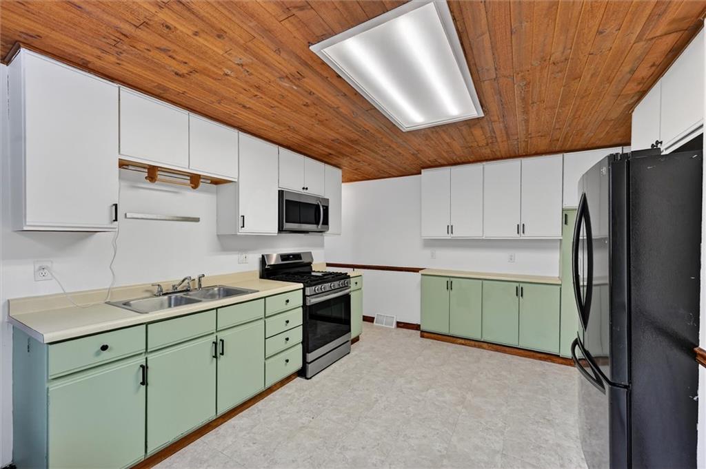 301 Milroy Street Pittsburgh, PA 15214 - Photo 12 of 24 a kitchen with a sink stainless steel appliances and cabinets