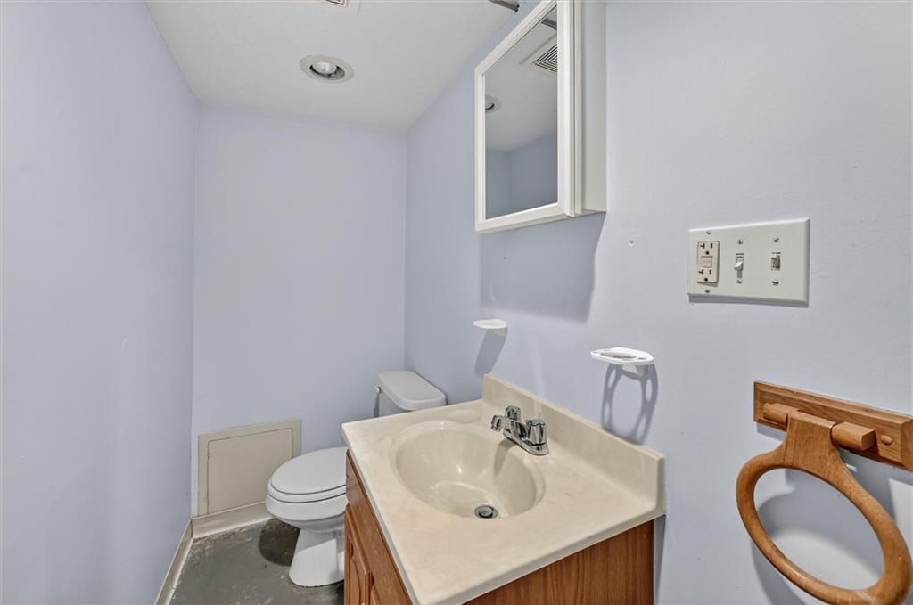 301 Milroy Street Pittsburgh, PA 15214 - Photo 21 of 24 a bathroom with a sink a toilet and a mirror