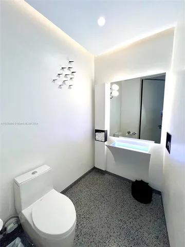 a bathroom with a double vanity sink mirror and toilet