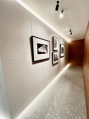 a view of hallway with stairs and wooden cabinet
