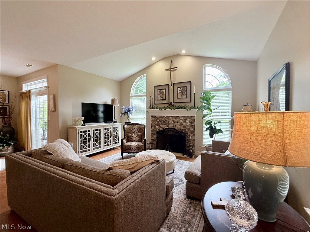 302 Wilcox Road Youngstown, OH 44515 - Photo 6 of 30 Vaulted ceiling with recessed lighting, brick-faced fireplace, arched windows, and a glass-paneled door
