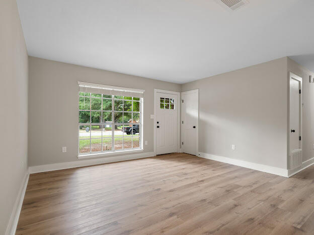 6180 Old Hickory Road Crestview, FL 32539 - Photo 17 of 31 a view of an empty room with wooden floor and a window