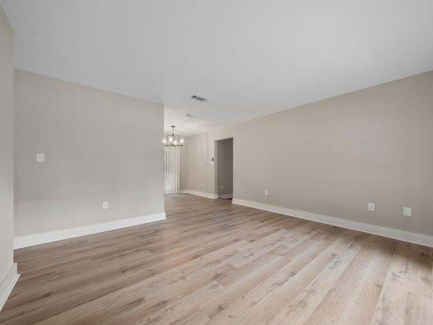 6180 Old Hickory Road Crestview, FL 32539 - Photo 19 of 31 a view of an empty room with wooden floor and a window